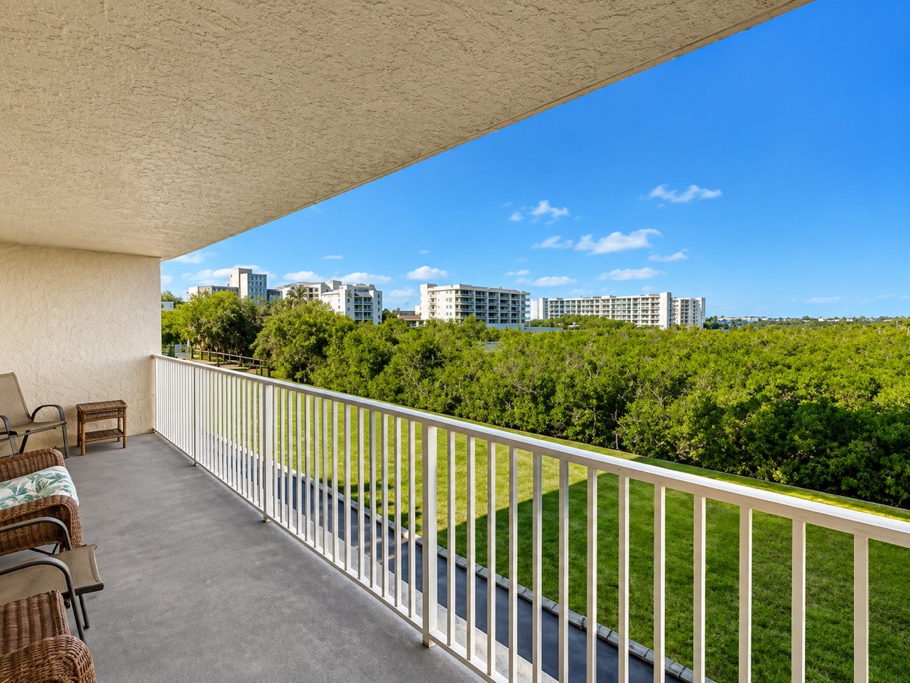 The view from the balcony, over the lawn and mangroves toward the water