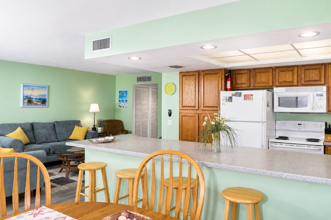 The kitchen seen across the breakfast bar, with the living room beyond