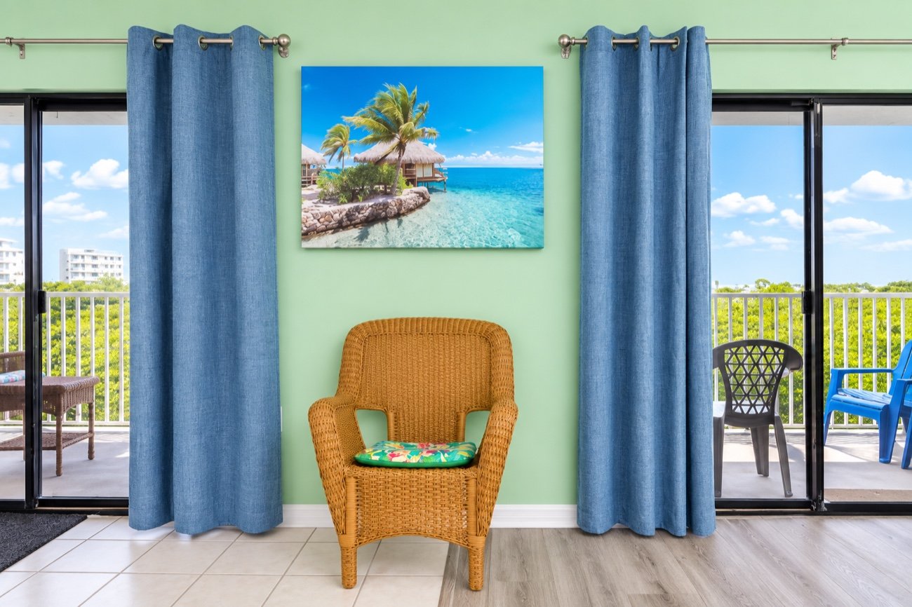 Sliding doors either side of a wicker chair, opening onto the balcony